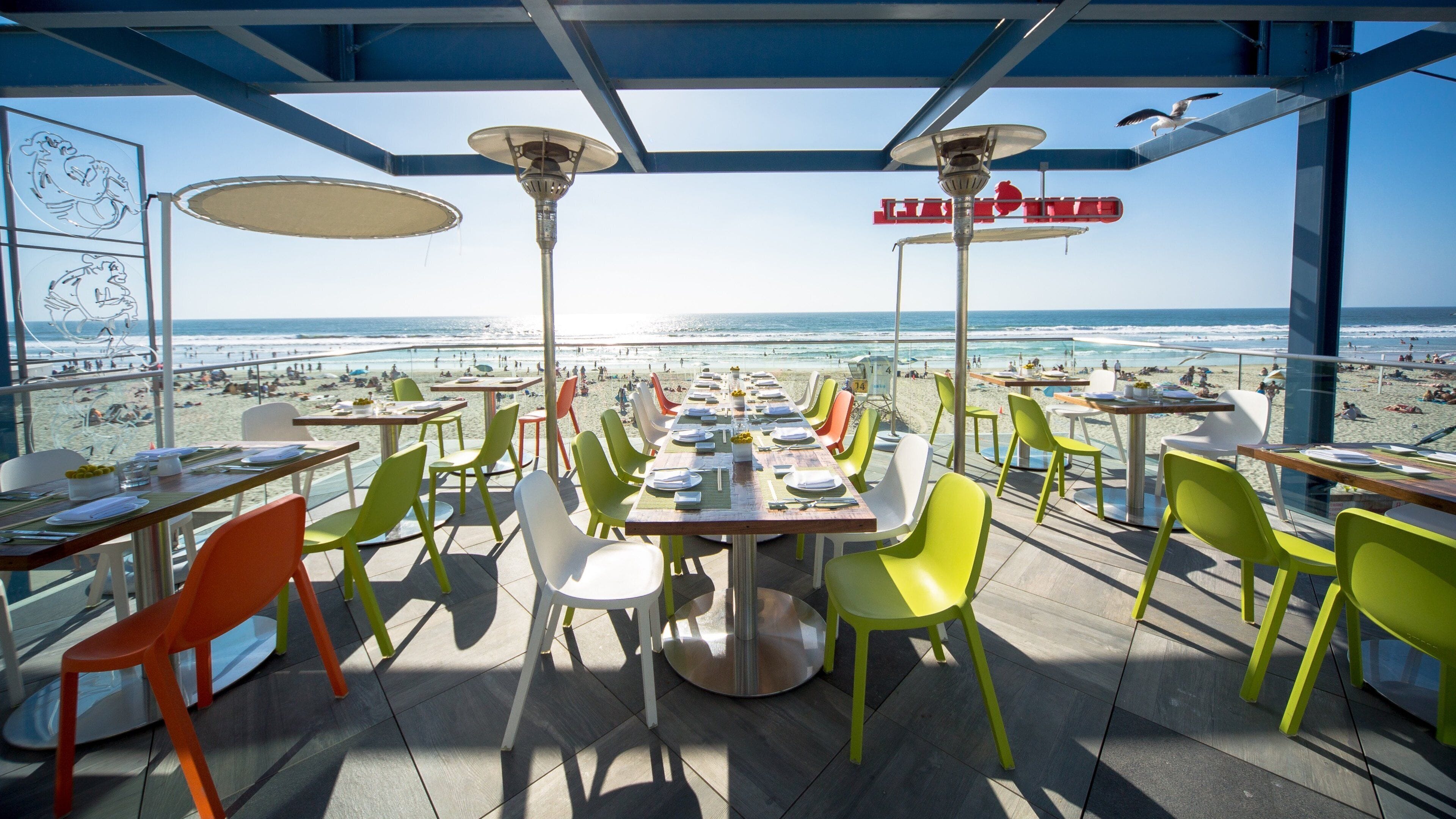 A restaurant with a view of the beach and ocean.