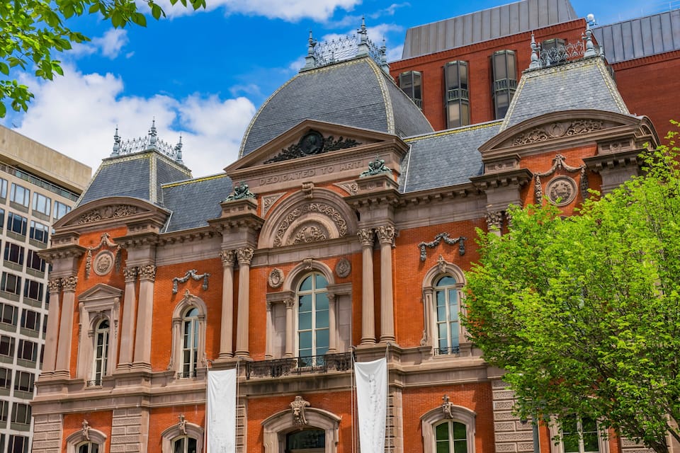 A historic building with ornate architecture, including a dome and decorative columns.