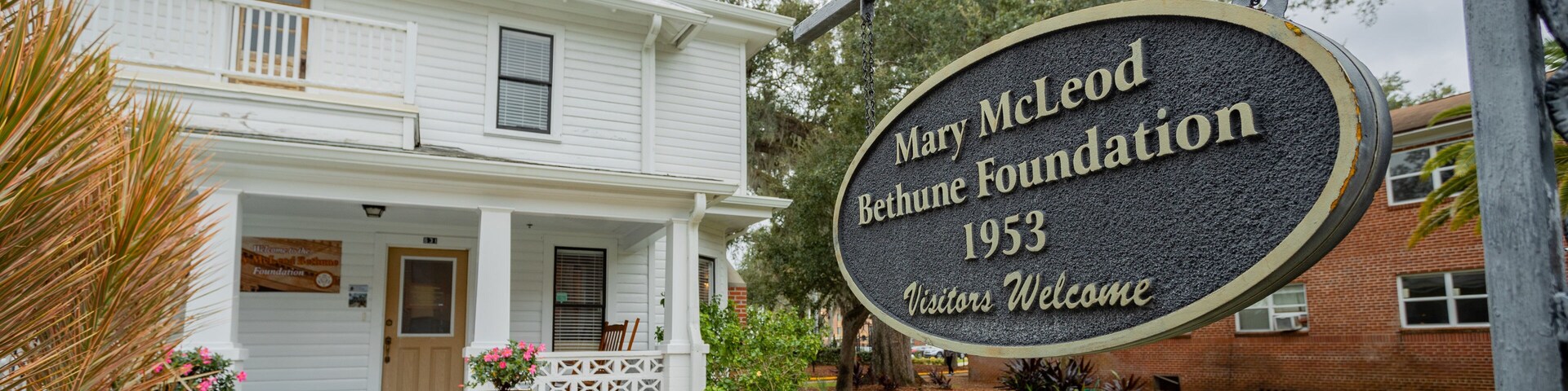 Mary Bethune Home featuring signage and a house