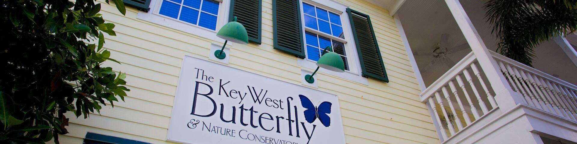 A building with a sign reading "The Key West Butterfly & Nature Conservatory".