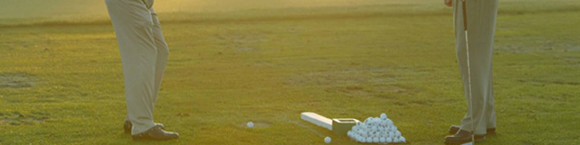 Grand Cypress Golf Club featuring a sunset and golf as well as a couple