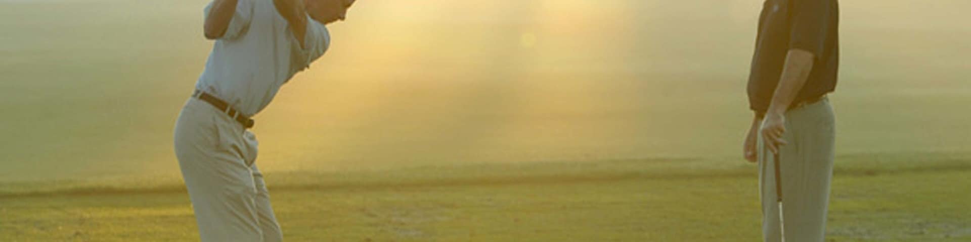 Grand Cypress Golf Club featuring a sunset and golf as well as a couple