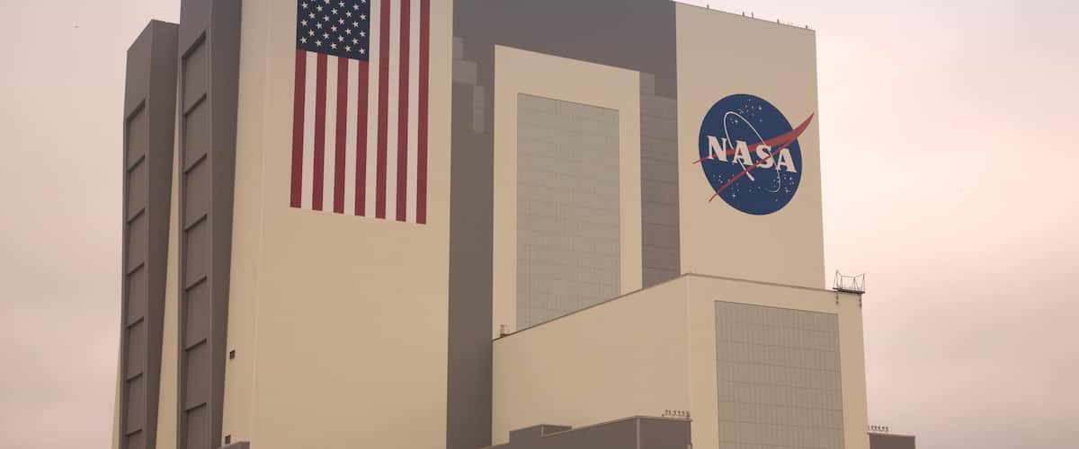 A large building with an American flag and a NASA logo.