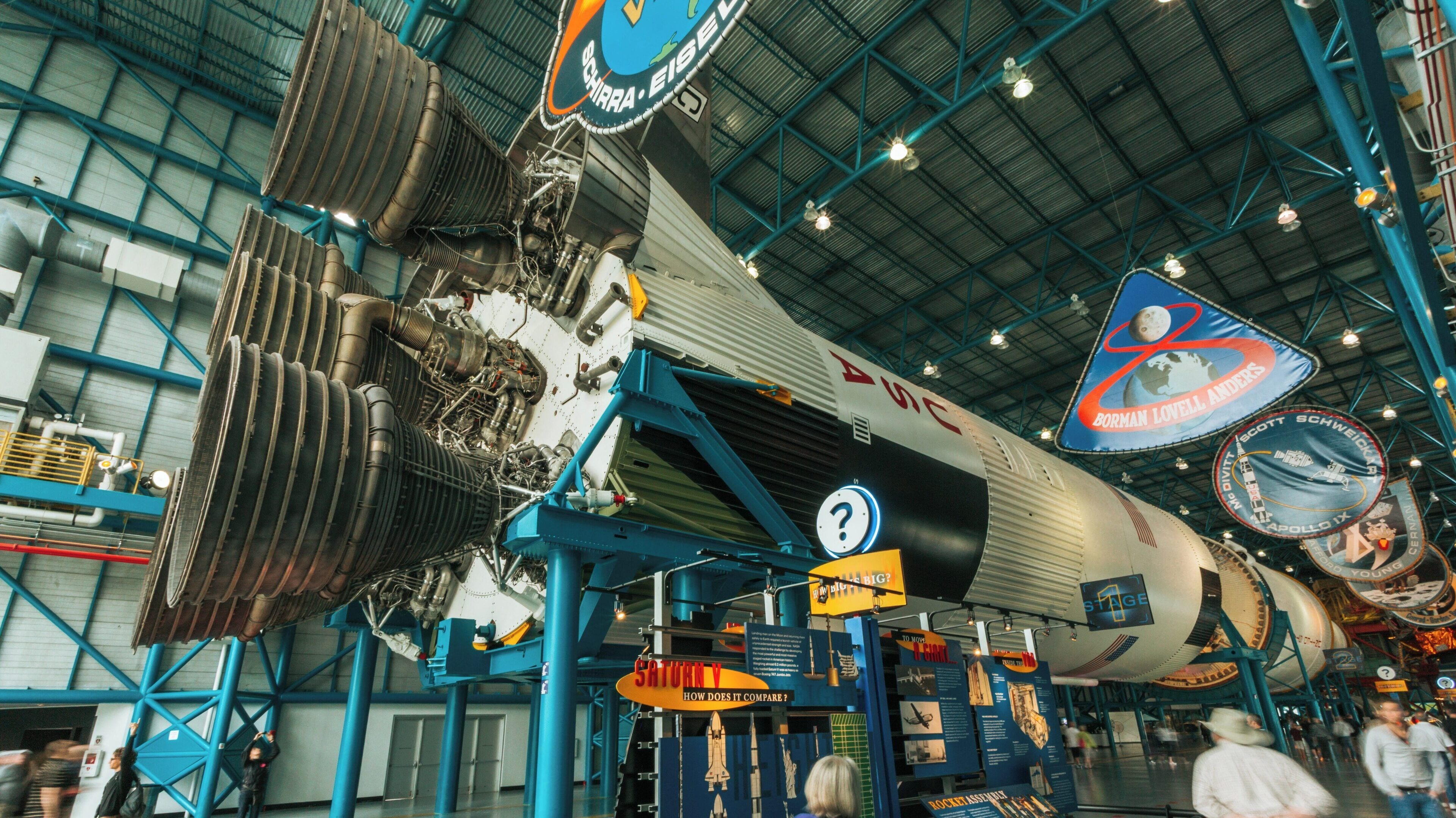 Exploration of space technology at Kennedy Space Center's rocket display in Cape Canaveral, Florida during a busy visitor day