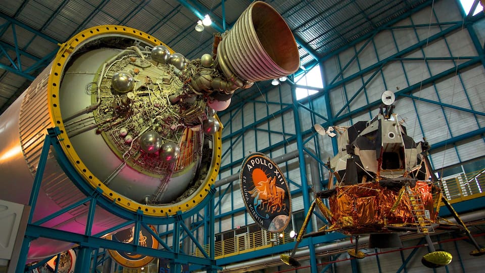 A spacecraft with the Apollo XII logo, a large circular dish, and a metallic structure with a yellow and blue frame.