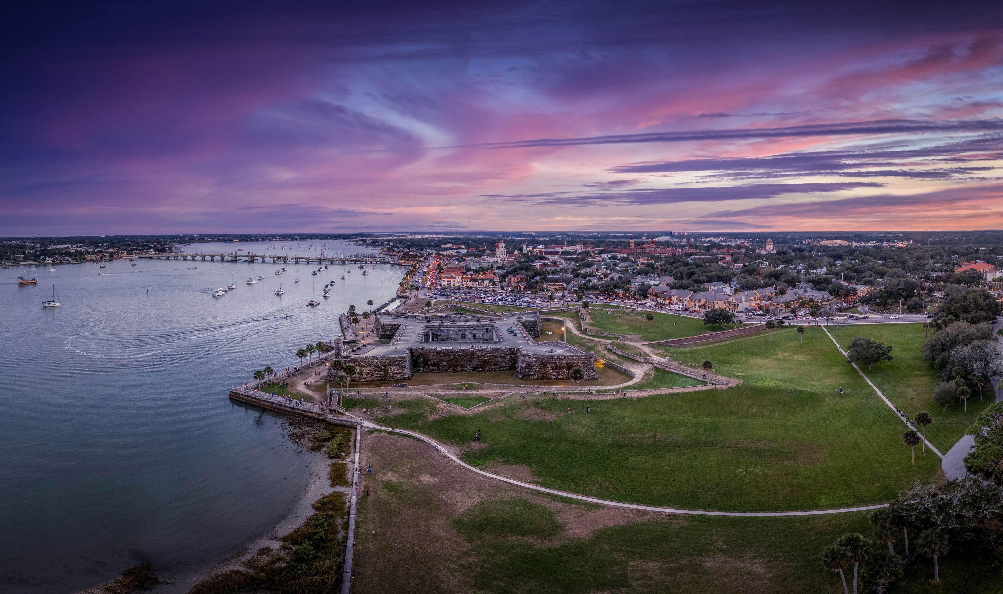Stunning aerial sunset shot of St Augustine Florida, Castillo de San Marcos with four cannon bastions purple, blue, red sky