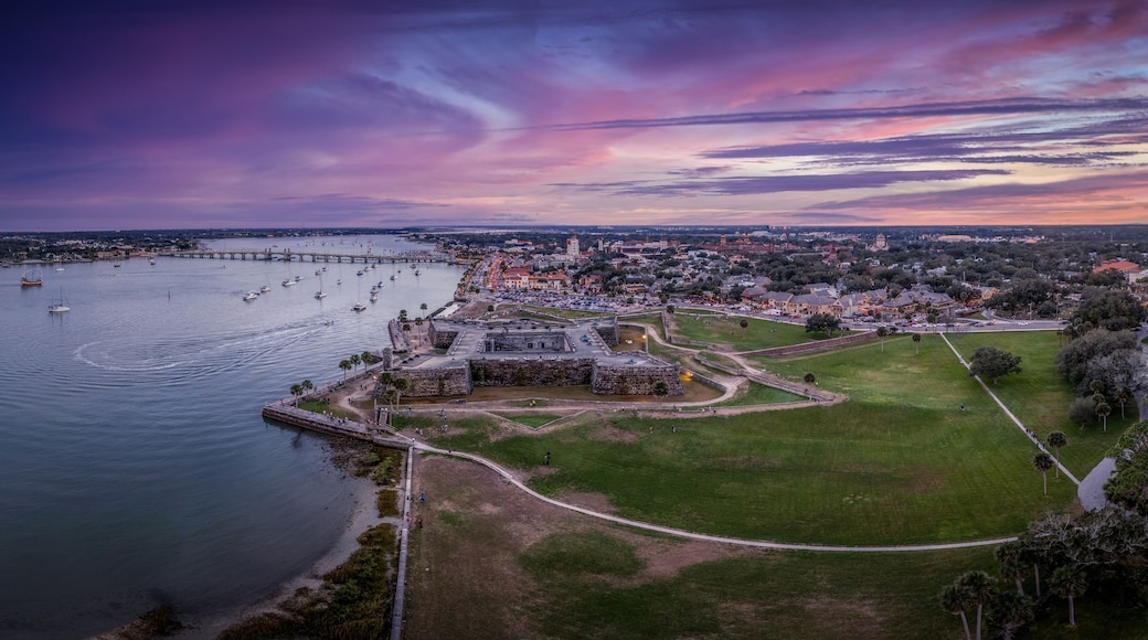 Stunning aerial sunset shot of St Augustine Florida, Castillo de San Marcos with four cannon bastions purple, blue, red sky