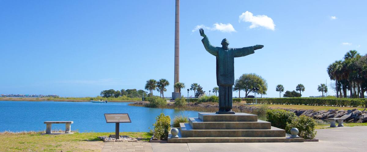 Mission of Nombre de Dios showing a lake or waterhole and a statue or sculpture