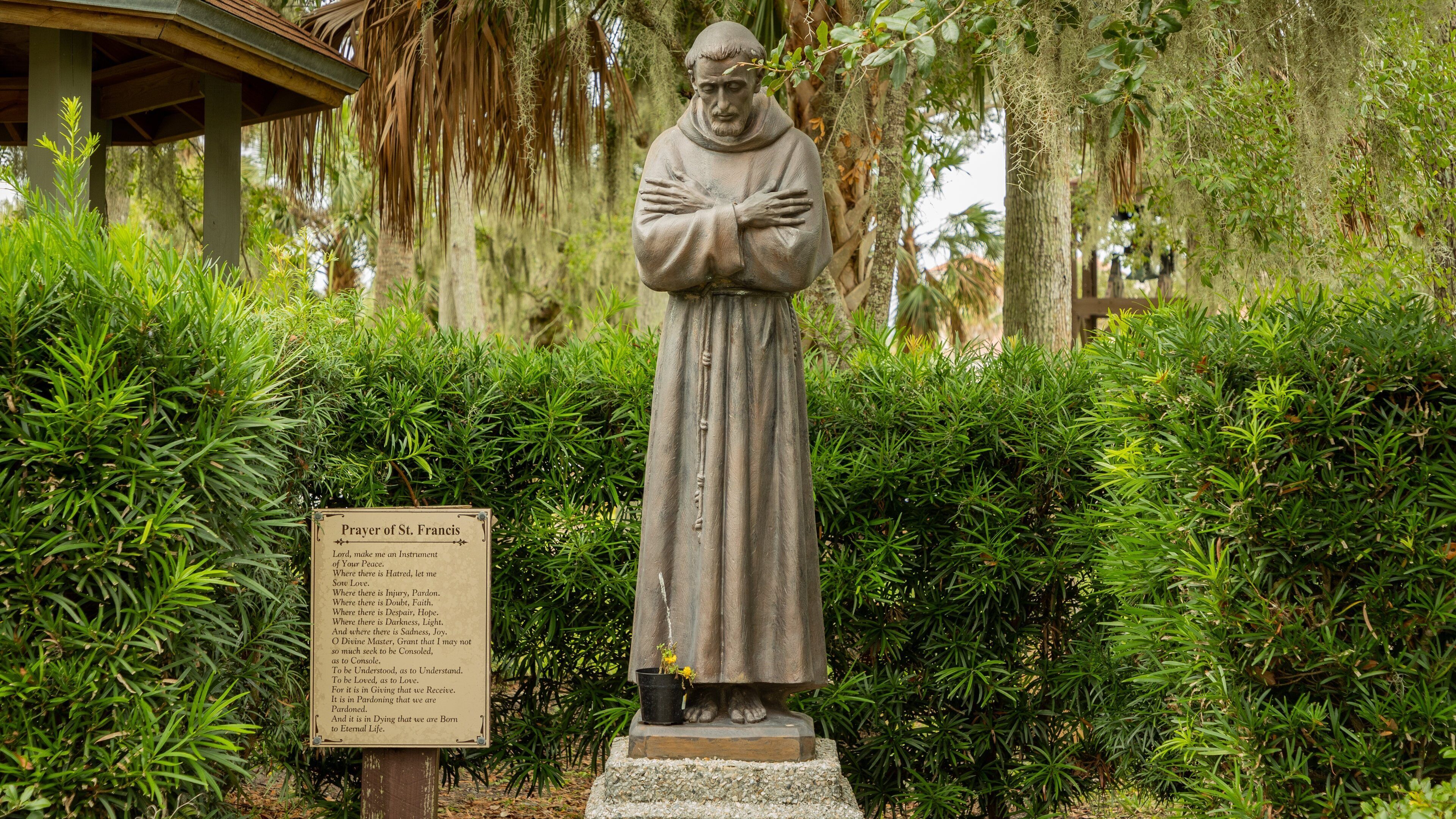 Mission of Nombre de Dios featuring a statue or sculpture and religious elements