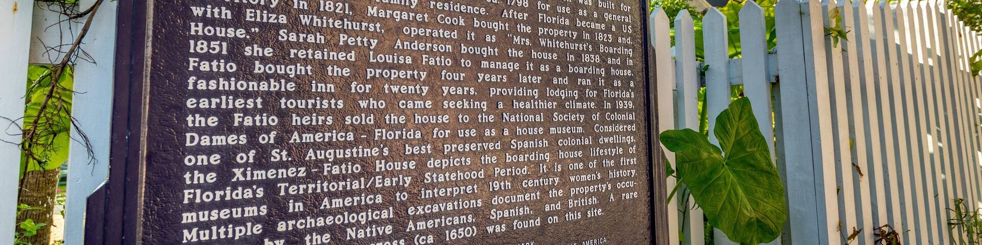A historical marker detailing the Ximenez-Fatio House, a Spanish merchant store, tavern, and family residence dating back to 1821.