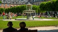 Place des Vosges featuring a fountain and a park