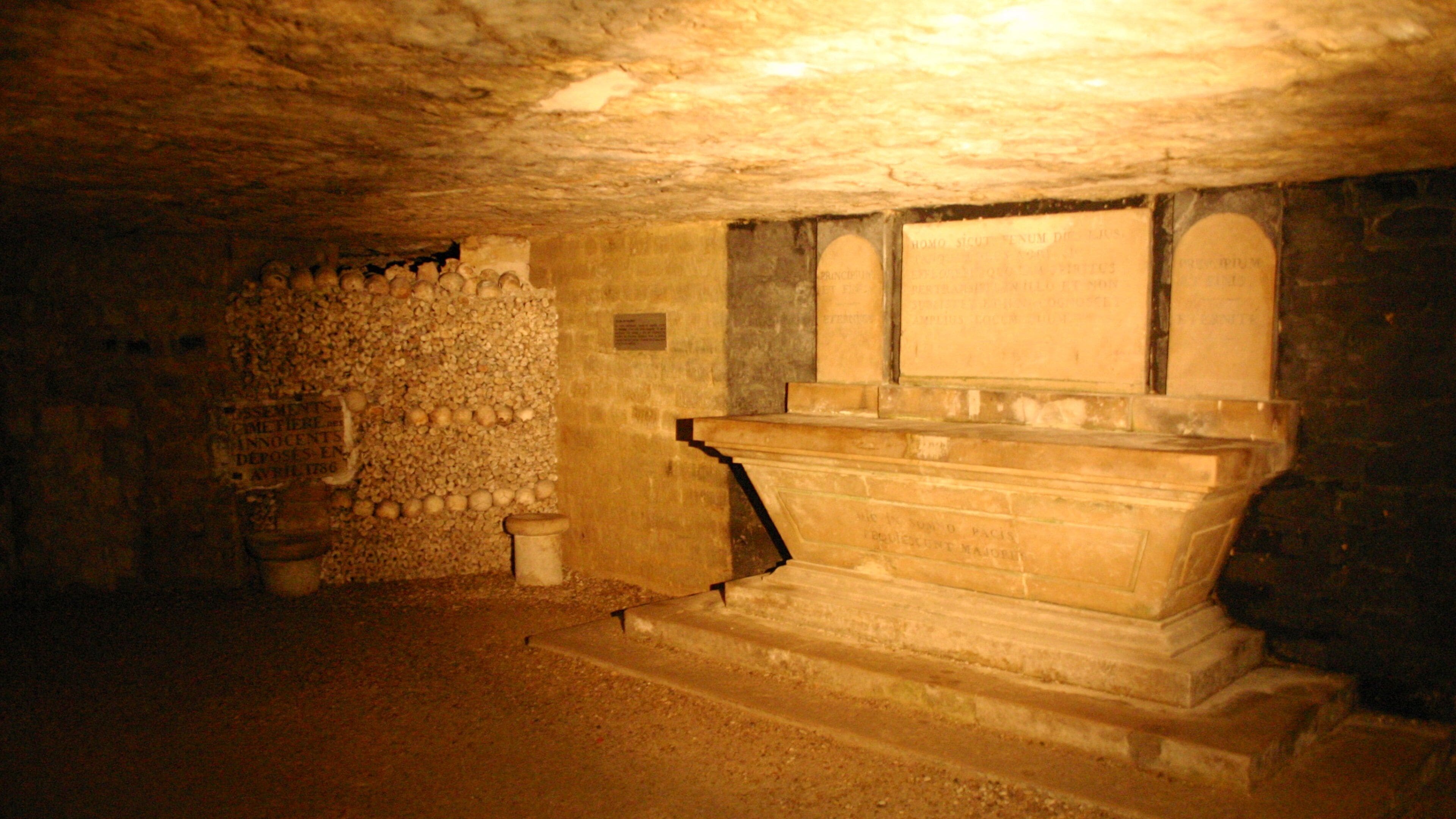 Explore the historic Paris Catacombs featuring ancient tombs and ossuaries beneath the city