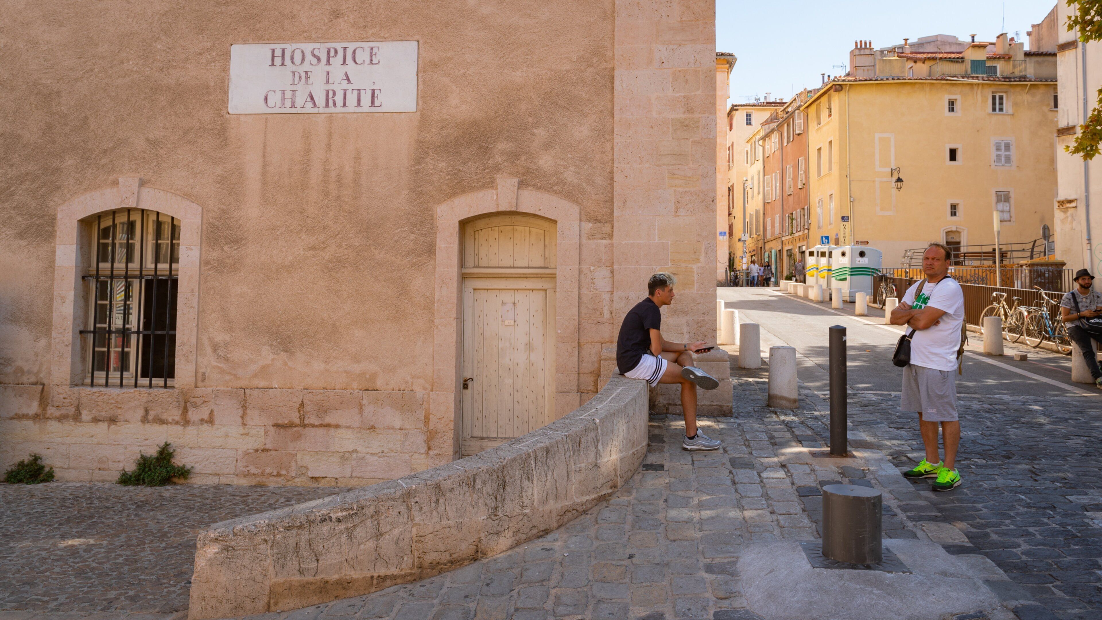 La Vieille Charite showing signage and street scenes as well as an individual male
