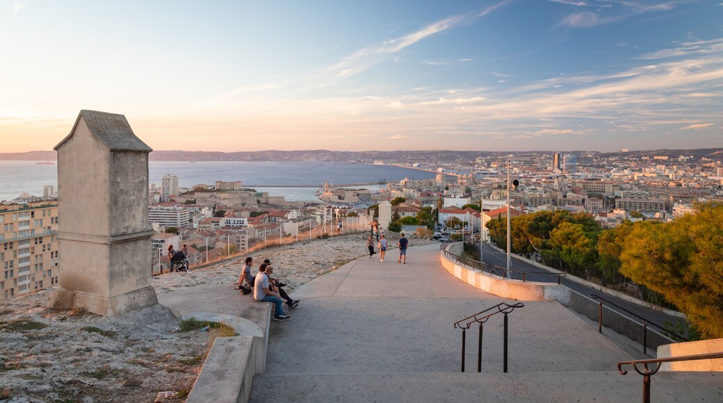 Notre-Dame de la Garde showing a coastal town, landscape views and a sunset