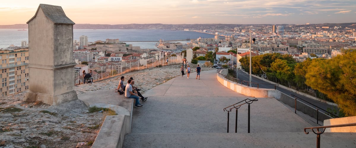 Notre-Dame de la Garde showing a coastal town, landscape views and a sunset