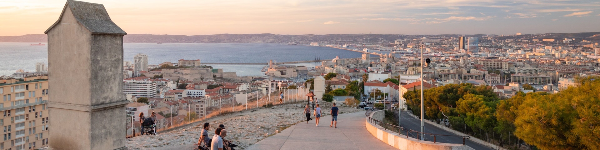 Notre-Dame de la Garde showing a coastal town, landscape views and a sunset