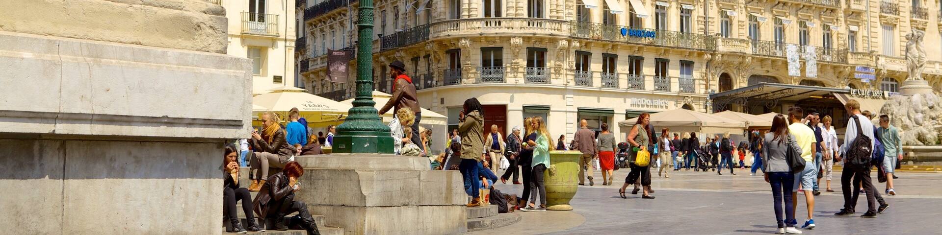 Comedy Square featuring street scenes as well as a large group of people