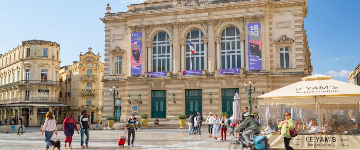 Comedy Square featuring street scenes and heritage architecture as well as a small group of people