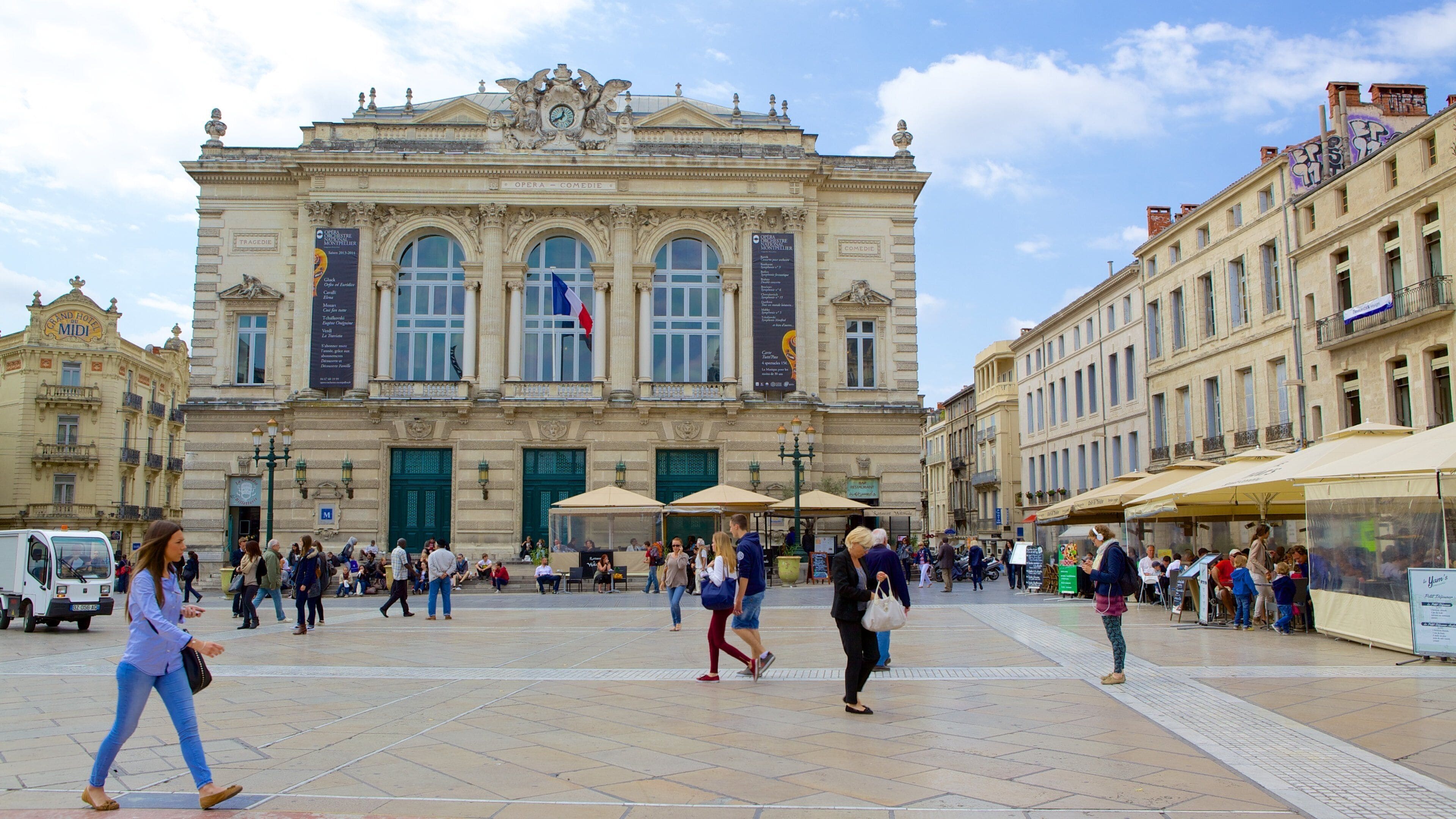 A historic opera house with ornate architecture and a large central entrance.
