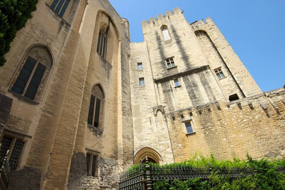 A historic stone castle with arched windows and a tall tower.
