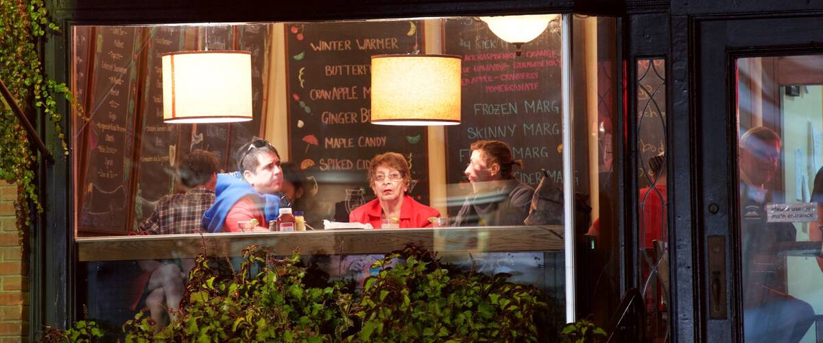 A restaurant with a chalkboard menu and a sign above that reads "Spirits" and "Fine Foods".