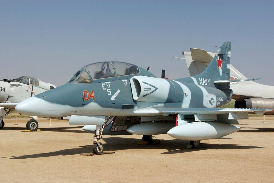 A military jet with the number 04 and the word "NAVY" on its tail.
