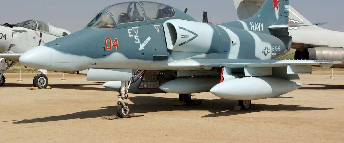 A military jet with the number 04 and the word "NAVY" on its tail.