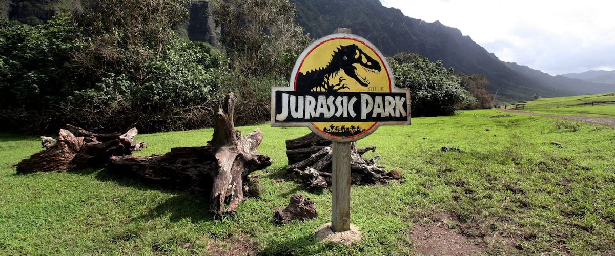 Kualoa Beach Park featuring mountains, a garden and signage