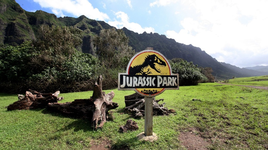 Kualoa Beach Park featuring mountains, a garden and signage