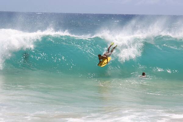 Makapuu Beach showing surfing and surf as well as an individual male