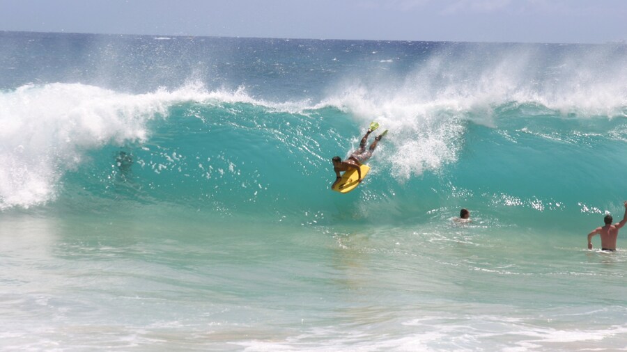 Makapuu Beach showing surfing and surf as well as an individual male