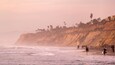 Torrey Pines State Beach showing a sunset, rugged coastline and general coastal views