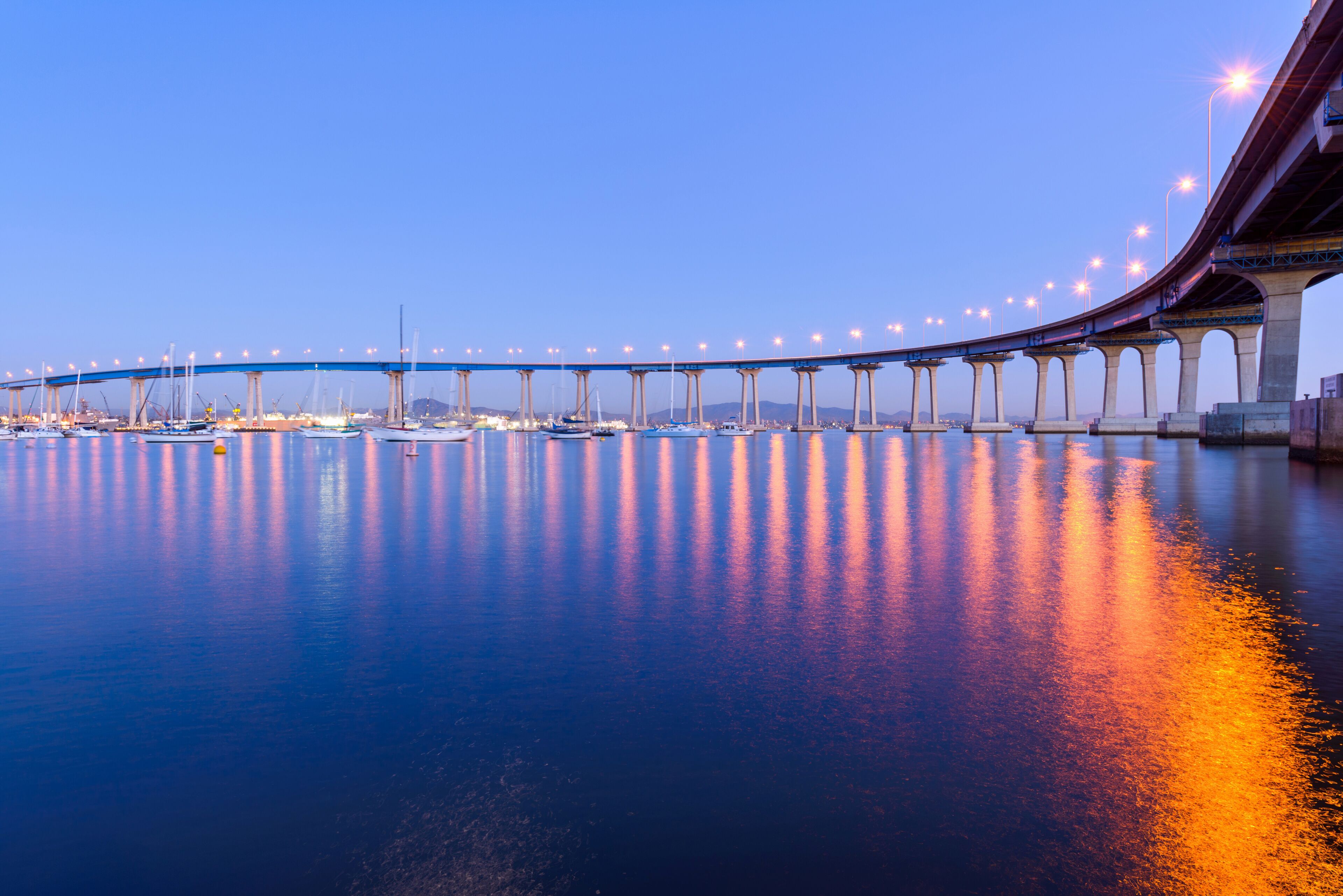 Coronado Bridge at Dusk - A close-up dusk view of Coronado Bridge, winding over calm San Diego Bay, at San Diego, California, USA.