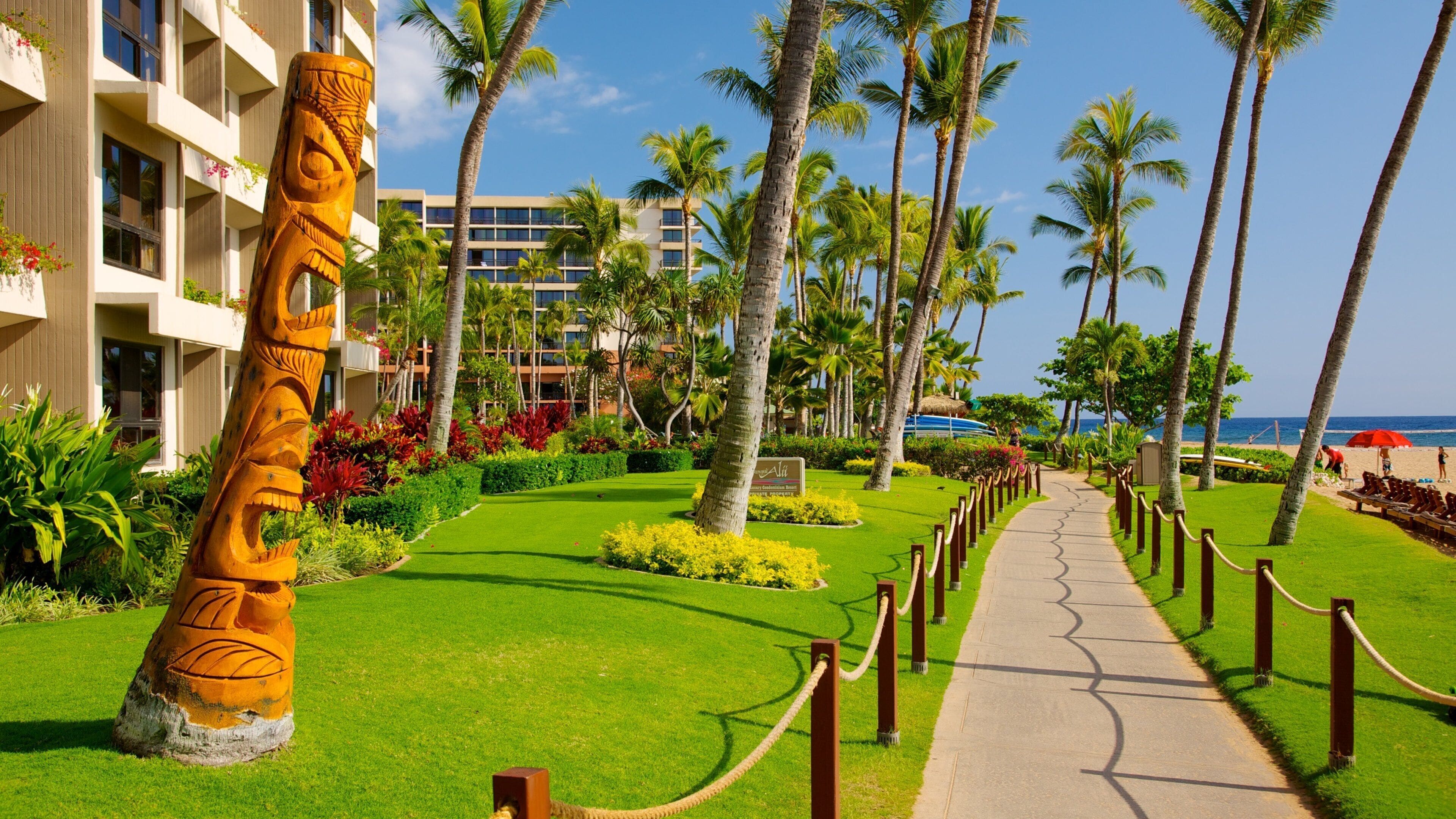 Kaanapali Beach featuring a coastal town, a sandy beach and tropical scenes