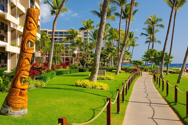Kaanapali Beach featuring a coastal town, a sandy beach and tropical scenes