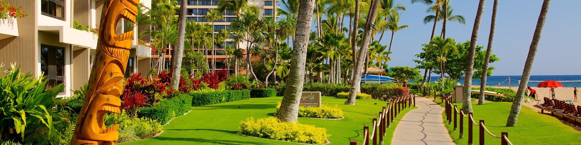 Kaanapali Beach featuring a coastal town, a sandy beach and tropical scenes
