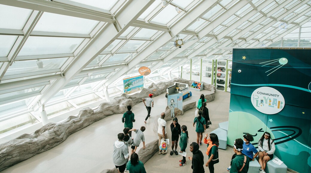 Adler Planetarium and Astronomy Museum featuring interior views as well as a small group of people