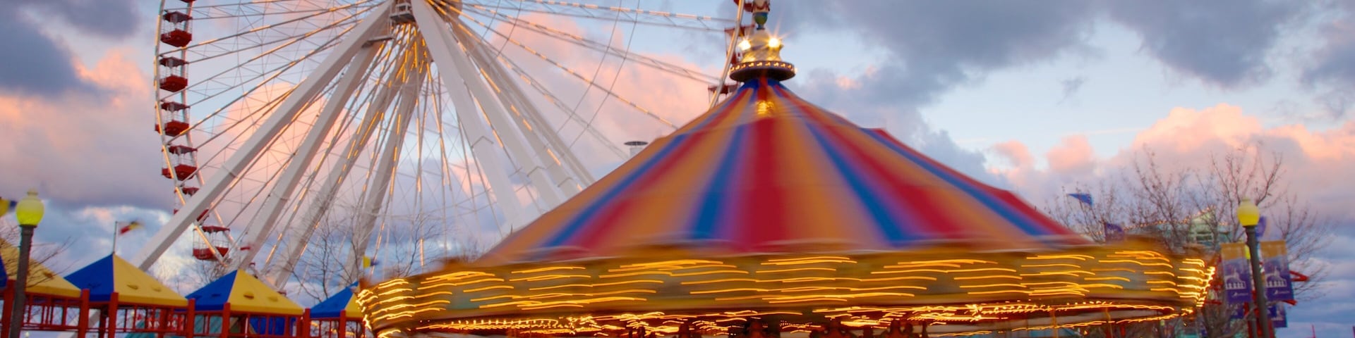 Navy Pier featuring a sunset and rides