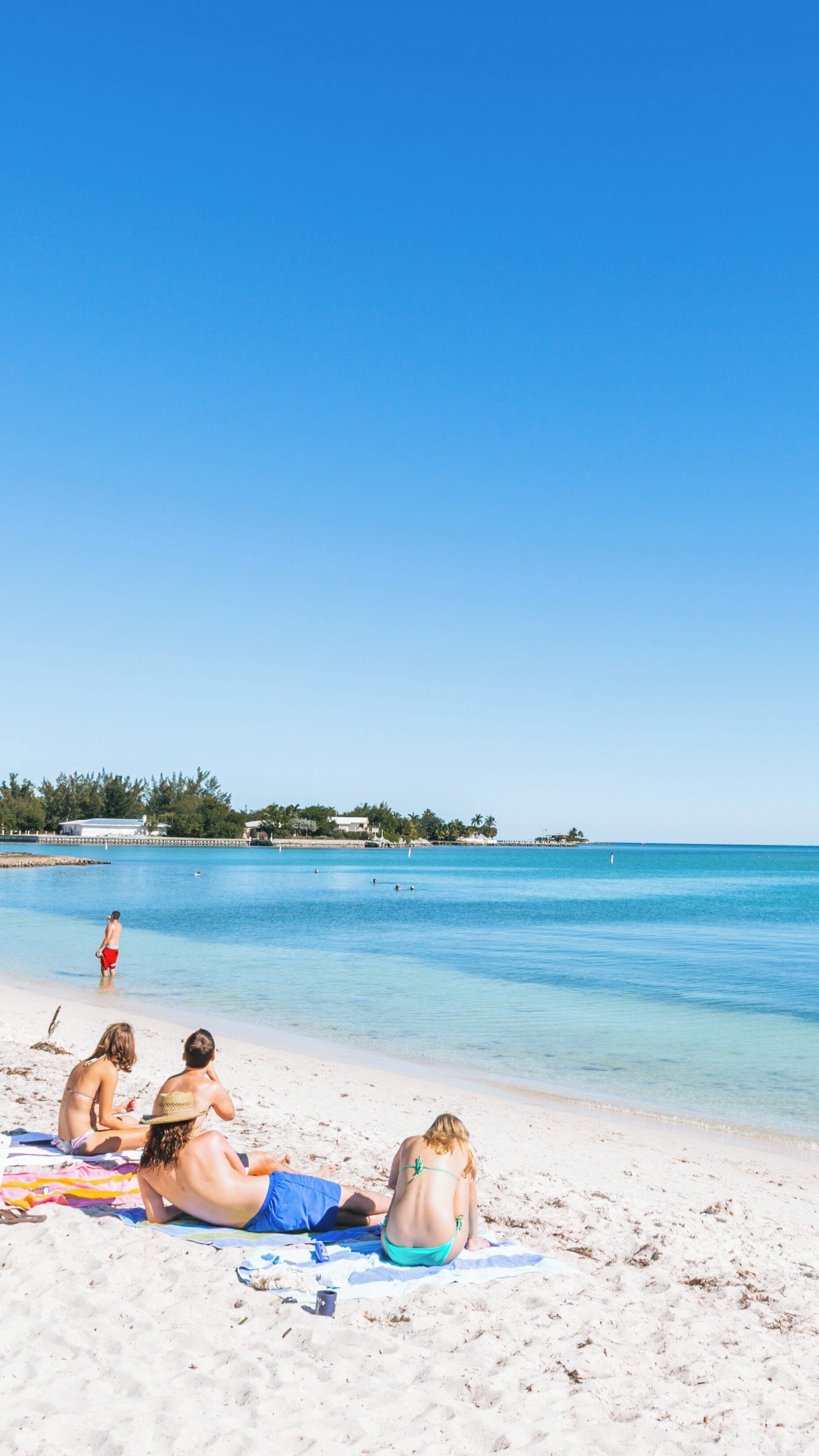 Relaxing at Sombrero Beach in Marathon, Florida with clear skies and calm waters on a sunny day