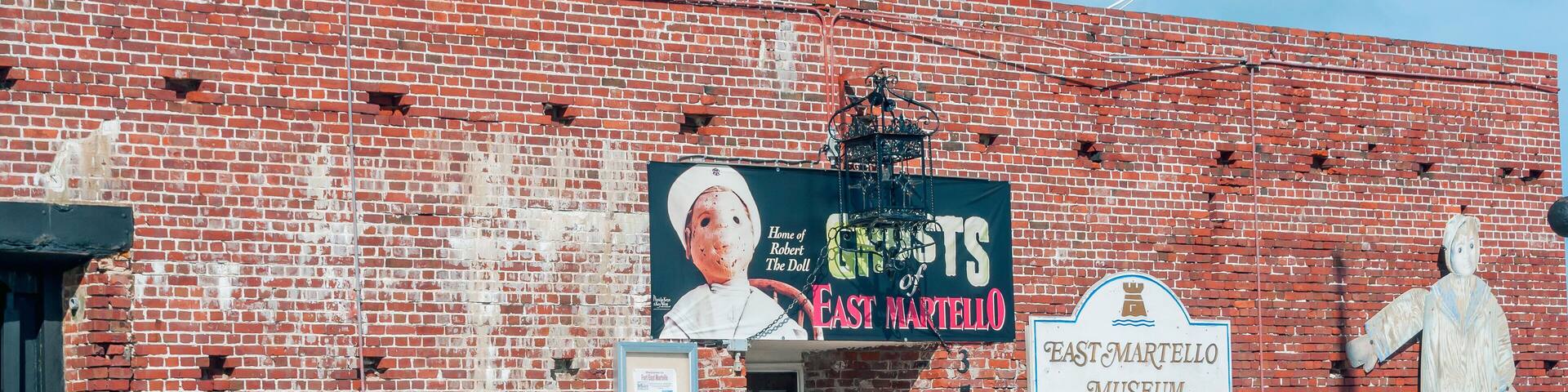 A brick building with a sign for the East Martello Museum.