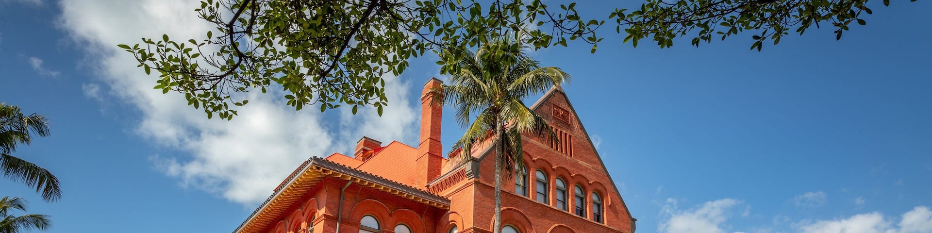 A large red brick building with arched windows and a prominent entrance.