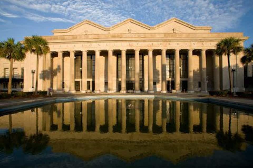 A neoclassical building with a reflecting pool in front.