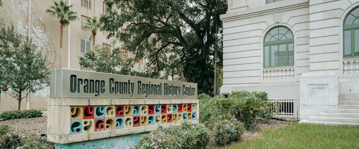 Orange County Regional History Center featuring signage and wildflowers