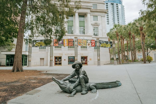 A statue of a man with a guitar in front of The History Center.