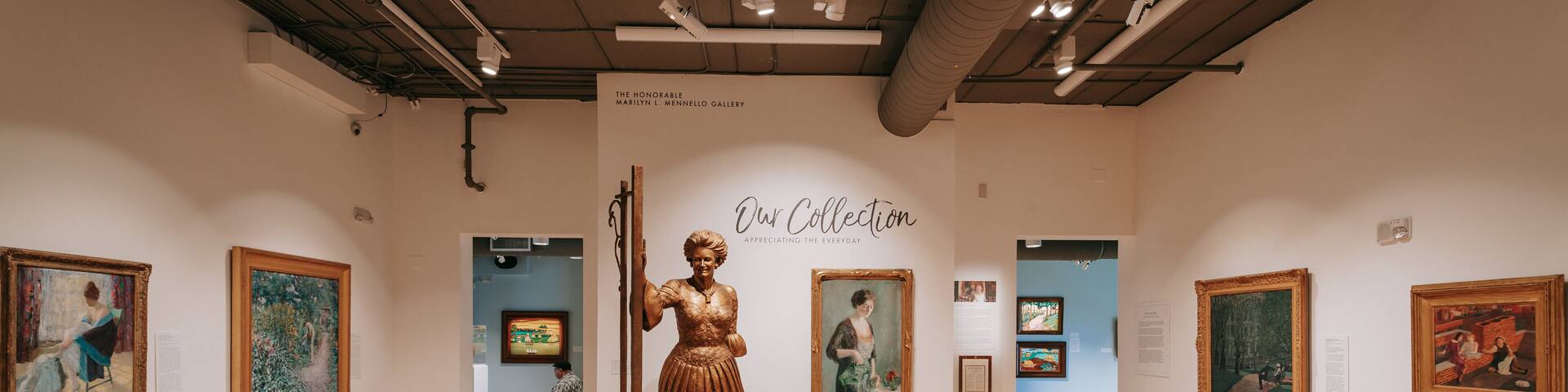 An art gallery with a central statue, framed paintings, and informational plaques.