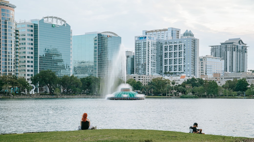 Lake Eola Park showing a bay or harbor, a city and a fountain