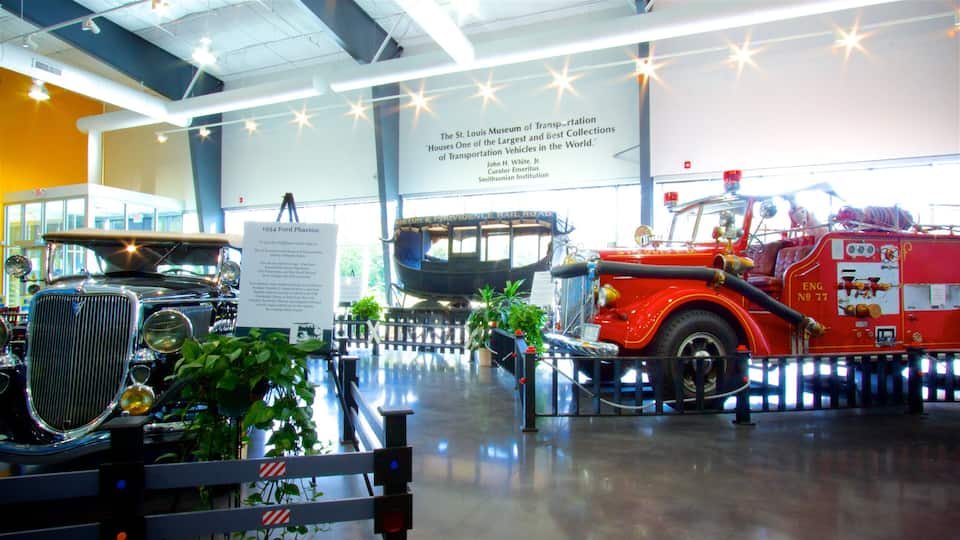 A museum exhibit with vintage vehicles including a 1934 Ford Phalet car and a fire truck.