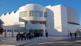 A modern building with a curved facade and large windows, labeled "Crocker."