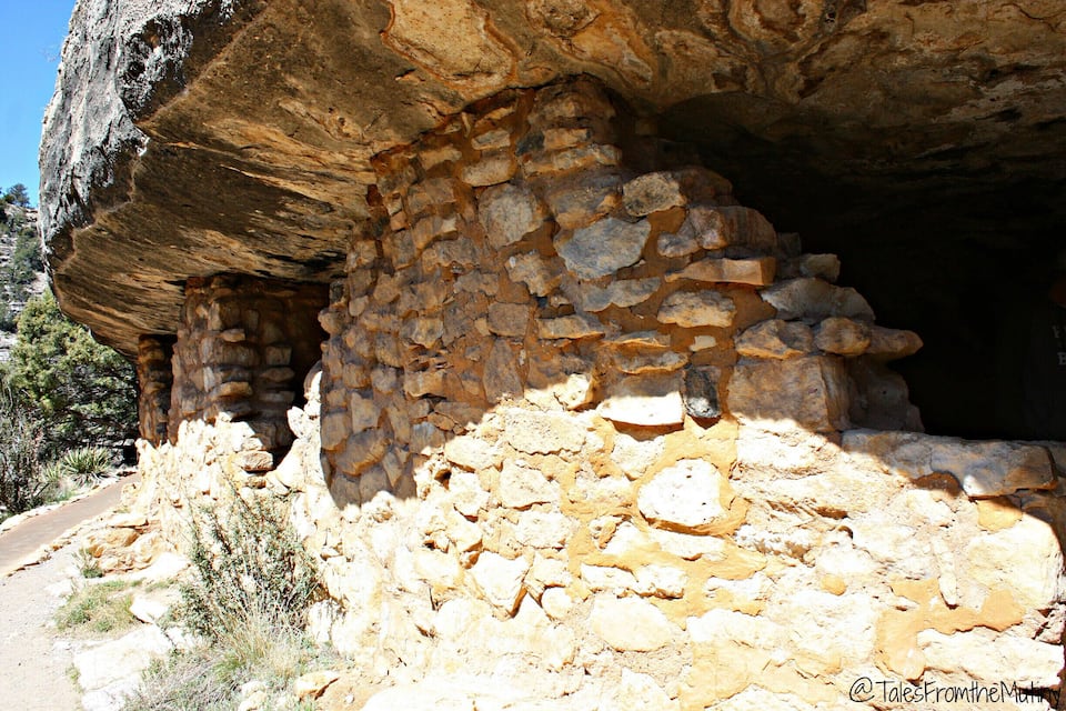 A large rock formation with a cave entrance.