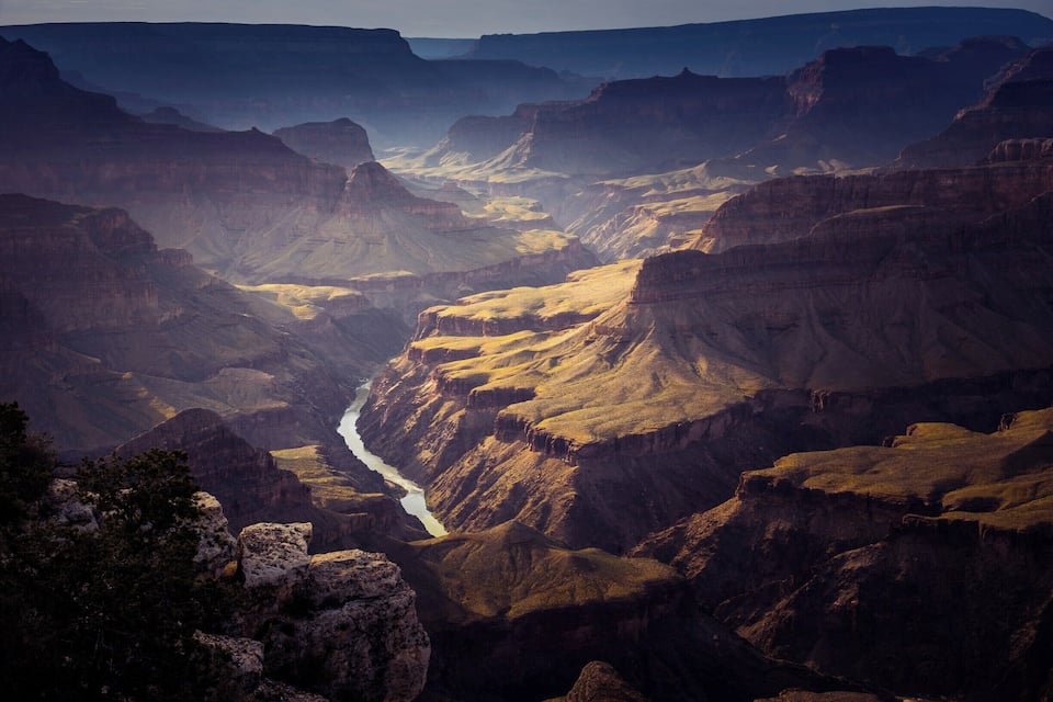 A canyon with a river flowing through it.